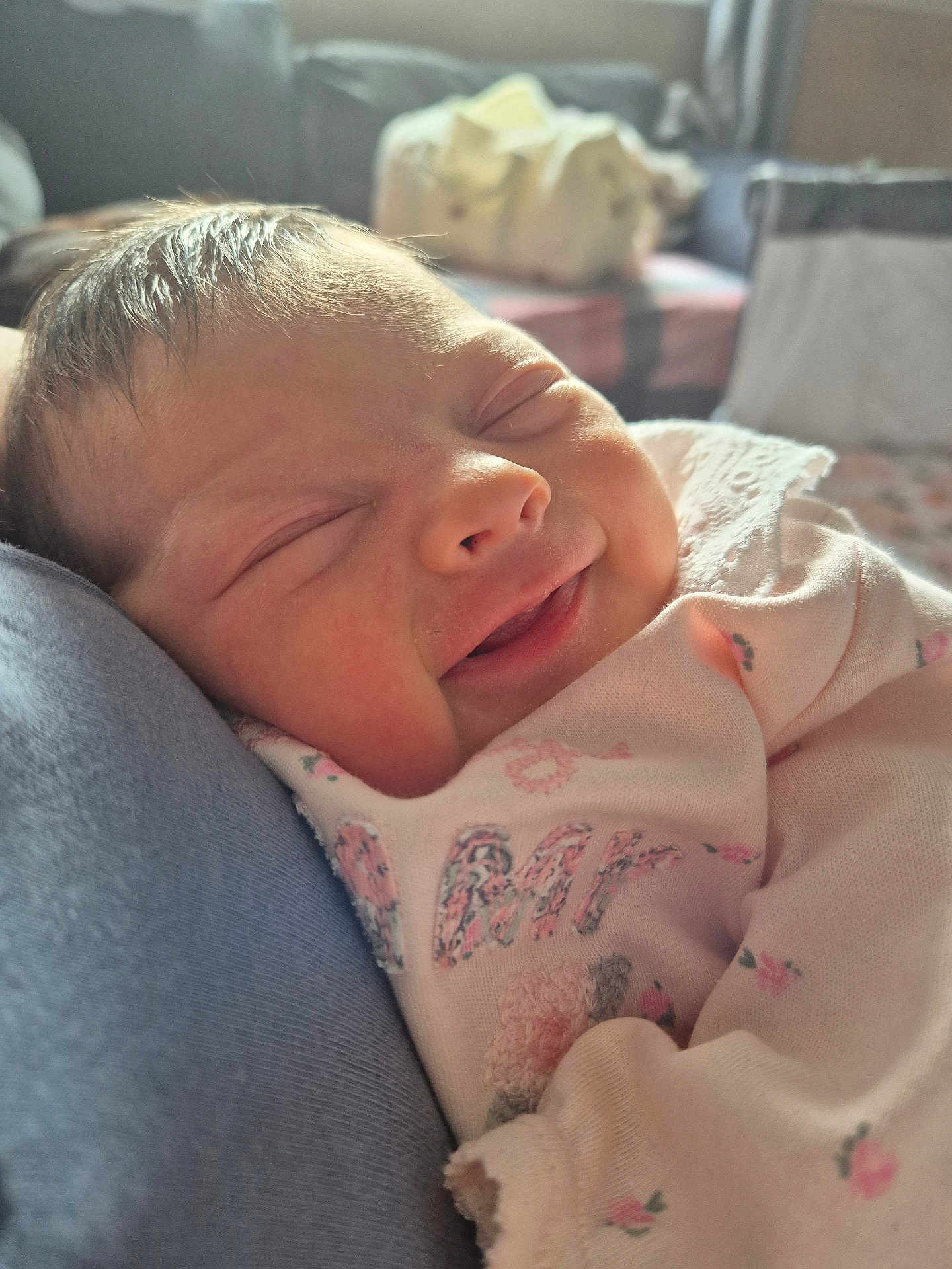 Robyn joined the competition — help win amazing prizes! baby, newborn, smile, sleeping, infant, cute, face, clothing, pink, floral_pattern, close_up, soft_light, indoor, portrait, peaceful, resting, child, person, cute_expression, warm