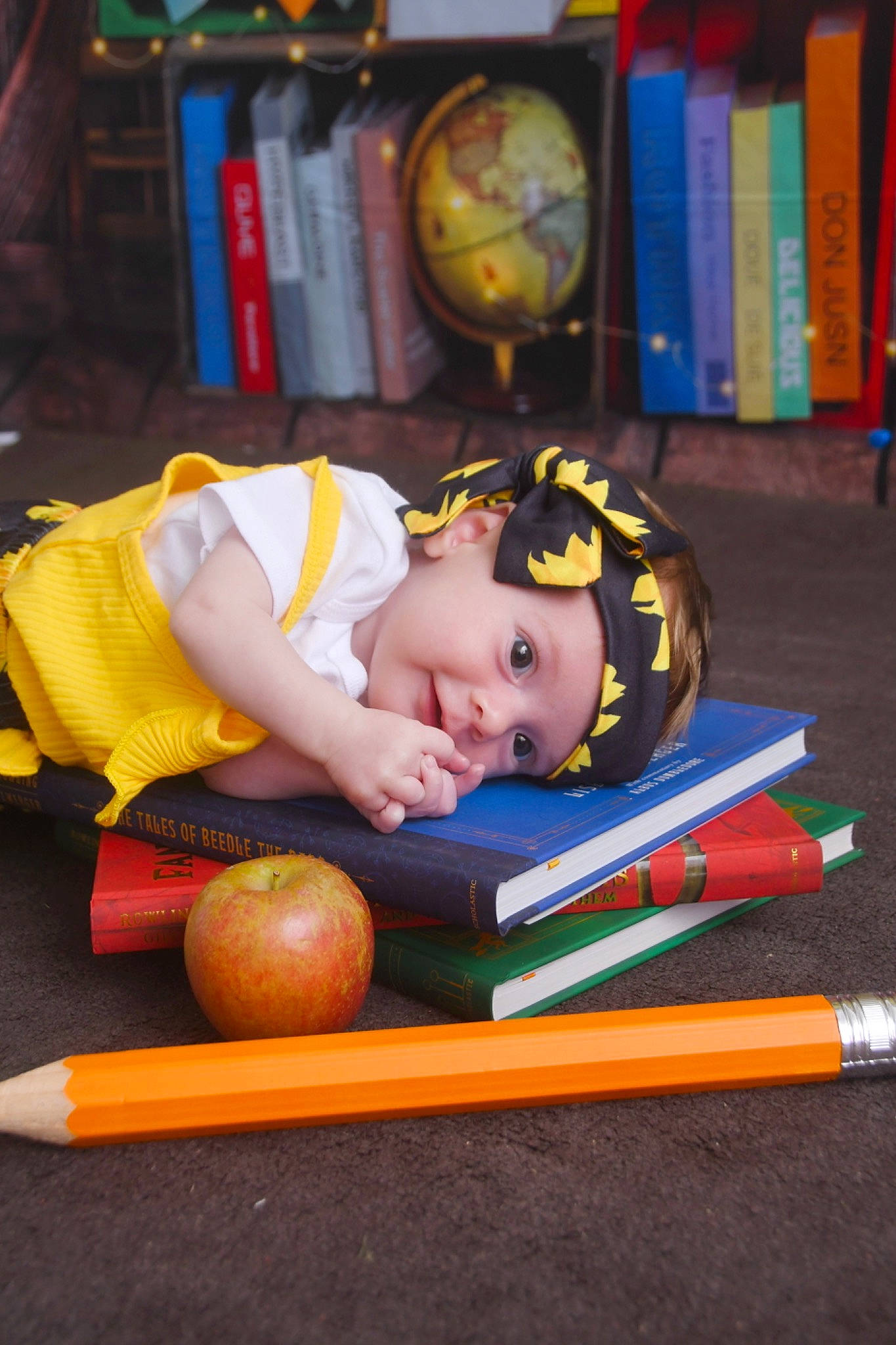 Josephine joined the competition — help win amazing prizes! baby, book, bookcase, calabaza, chair, child, eye, flooring, fun, headwear, leisure, natural_foods, person, play, publication, pumpkin, room, shelf, toddler, vegetable