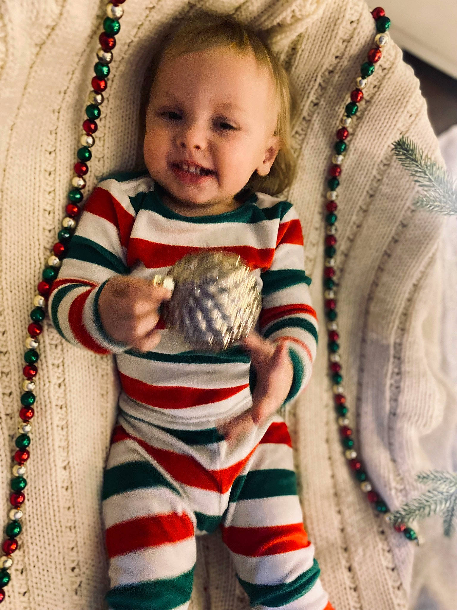 Luka is registered to the contest to win money with this photo: arm, baby_toddler_clothing, face, facial_expression, fawn, gesture, hand, happy, head, neck, organ, outerwear, person, plaid, skin, sleeve, smile, standing, t_shirt, textile