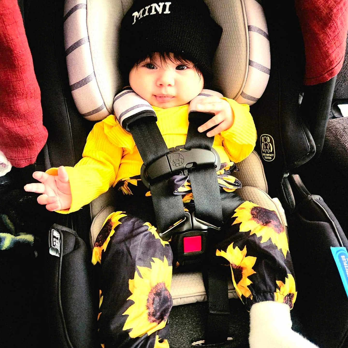 Serena is registered to the contest to win money with this photo: baby, cap, clothing, coat, cushion, face, footwear, glove, hat, head, homedecor, jacket, pants, person, photography, portrait, shoe, sitting, transportation, vehicle