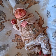 Jaxon is registered to the contest to win money with this photo: baby, newborn, sleeping, blanket, bambi, clothing, hat, footwear, pattern, cute, infant, soft, cozy, child, indoors, relaxing, peaceful, portrait, lying_down, animal_print