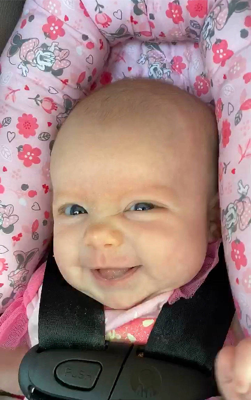 Blair is registered to the contest to win money with this photo: baby, baby_products, car_seat, cheek, child, face, forehead, head, headwear, joy, lip, mouth, nose, person, pink, skin, smile, toddler