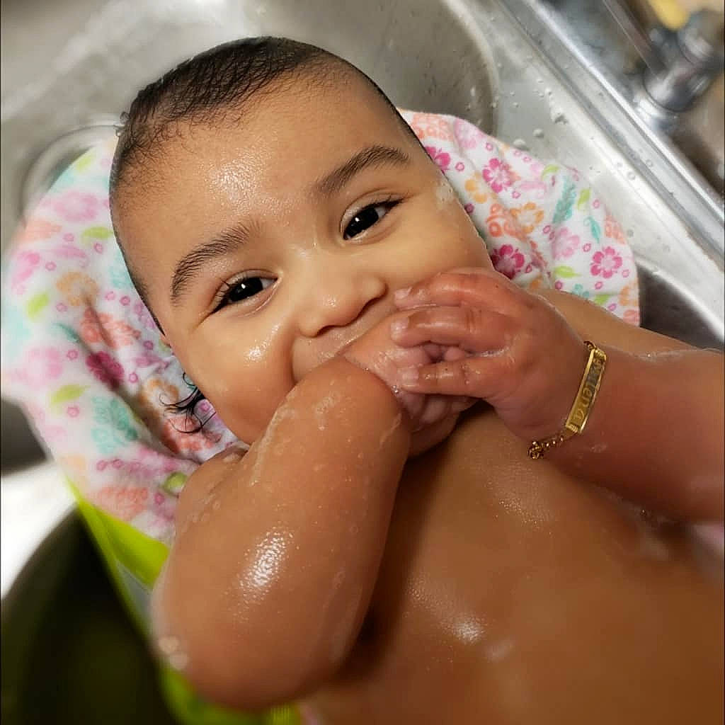 Milena is registered to the contest to win money with this photo: bathing, cheek, child, chin, face, finger, hand, head, infant, joy, lip, mouth, nail, nose, person, skin, toddler