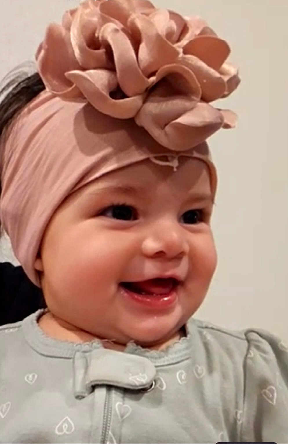 Avleen is registered to the contest to win money with this photo: baby, smiling, headband, flower, face, infant, cute, happy, clothing, heart_pattern, portrait, child, closeup, indoors, young, apparel, headwear, cheerful, baby_girl, adorable