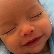 Hûd participe au concours pour gagner de l'argent avec cette photo : baby, infant, sleeping, smiling, closeup, face, eyelashes, cheek, nose, mouth, newborn, blanket, blue_blanket, cozy, soft_texture, pacifier, clothing, portrait, peaceful, skin