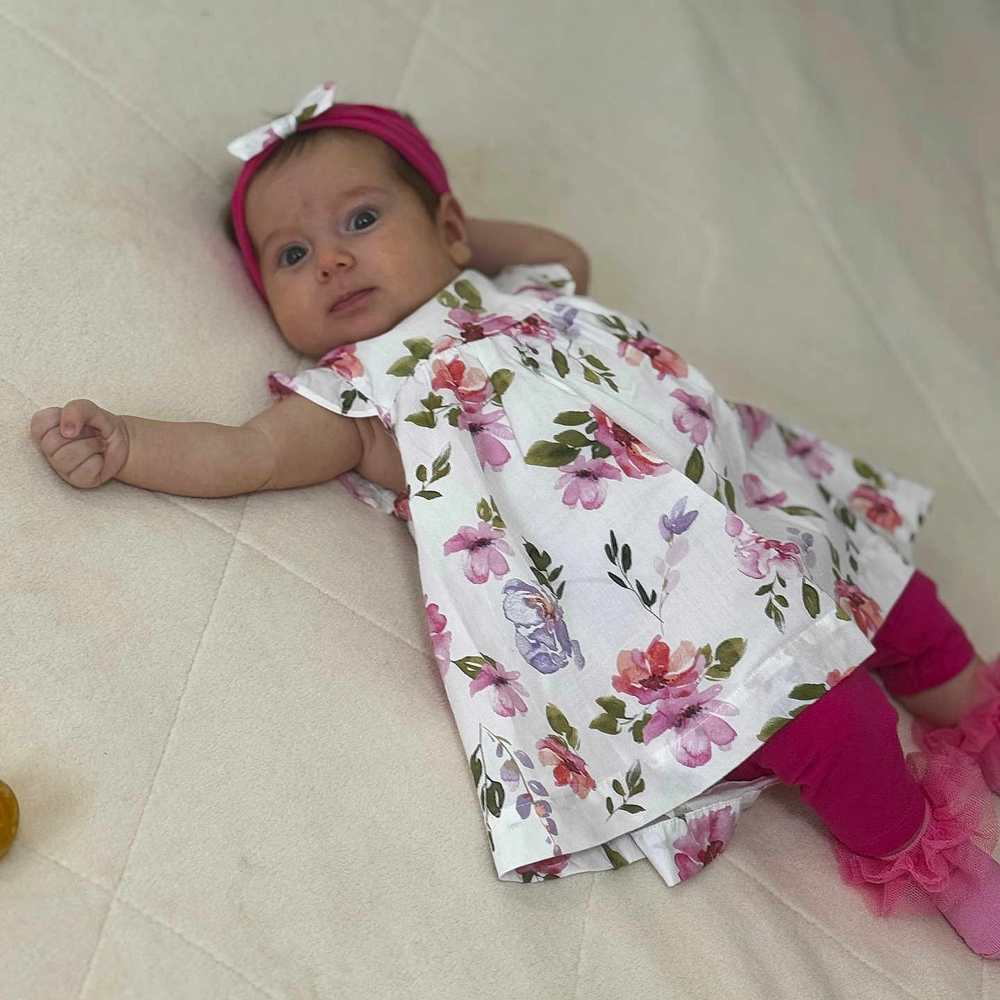 Eva Maria a rejoint le concours — aidez-le/la à gagner de superbes lots ! adorable, baby, blanket, child, curious, cute, fashion, floral_dress, happy, headband, indoors, infant, leggings, lying_down, person, pink, portrait, small_hands, soft_texture, young_child