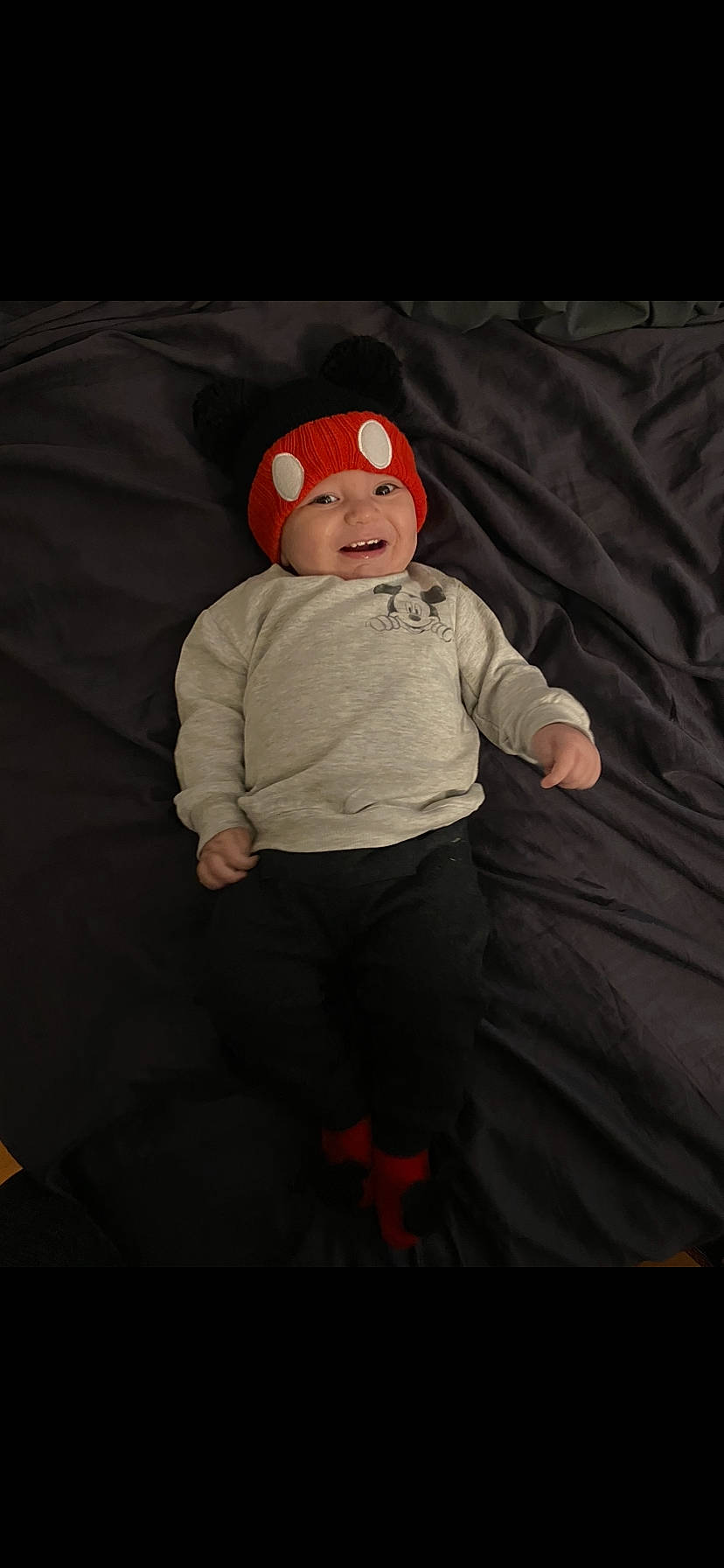 Dj is registered to the contest to win money with this photo: baby, baby_toddler_clothing, cap, carmine, child, comfort, darkness, eyewear, flash_photography, flooring, fun, headwear, joy, linens, pattern, person, sitting, sleeve, smile, t_shirt