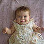 Lena participe au concours pour gagner de l'argent avec cette photo : baby, blanket, child, cute, dress, eyes, fabric, hand, happy, head, indoors, infant, lying_down, person, portrait, skin, smile, soft, striped_clothing, toddler