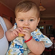 Lena participe au concours pour gagner de l'argent avec cette photo : adult, baby, biscuits, bracelet, child, clothing, curious, cute, face, furniture, hand, holding, home, indoor, light_fixture, pacifier_clip, person, portrait, smile, window