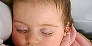 Lena participe au concours pour gagner de l'argent avec cette photo : baby, calm, child, closeup, comfort, cute, eyelashes, face, hair_ties, indoors, infant, peaceful, pigtails, pink_clothing, portrait, resting, skin, sleeping, soft_light, warm