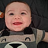 Ian is registered to the contest to win money with this photo: apparel, baby, bed, blanket, child, closeup, clothing, cute, expression, face, happy, infant, lying_down, person, portrait, skin, smiling, striped, textile, young
