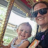 toddler, child, adult, woman, smiling, selfie, carousel, amusement_park, ride, pole, sunglasses, outdoor, portrait, family, happy, striped_dress, braided_hair, colorful, daylight, photography