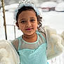child, girl, princess, dress, blue_dress, headband, tiara, winter, snow, coat, fur_coat, outdoor, portrait, smile, curly_hair, young, cute, fashion, holiday, cold_weather