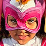 Laura joined the competition — help win amazing prizes! child, face, mask, costume, pink, white, superhero, close_up, portrait, smile, eyes, sunlight, outdoor, curly_hair, fabric, play, happy, childhood, young, fun