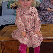 Sofia joined the competition — help win amazing prizes! child, toddler, smiling, pink_dress, tights, black_shoes, wooden_furniture, woman, glasses, living_room, couch, blanket, hair_bows, indoor, portrait, happy, person, seated, casual_clothing, family