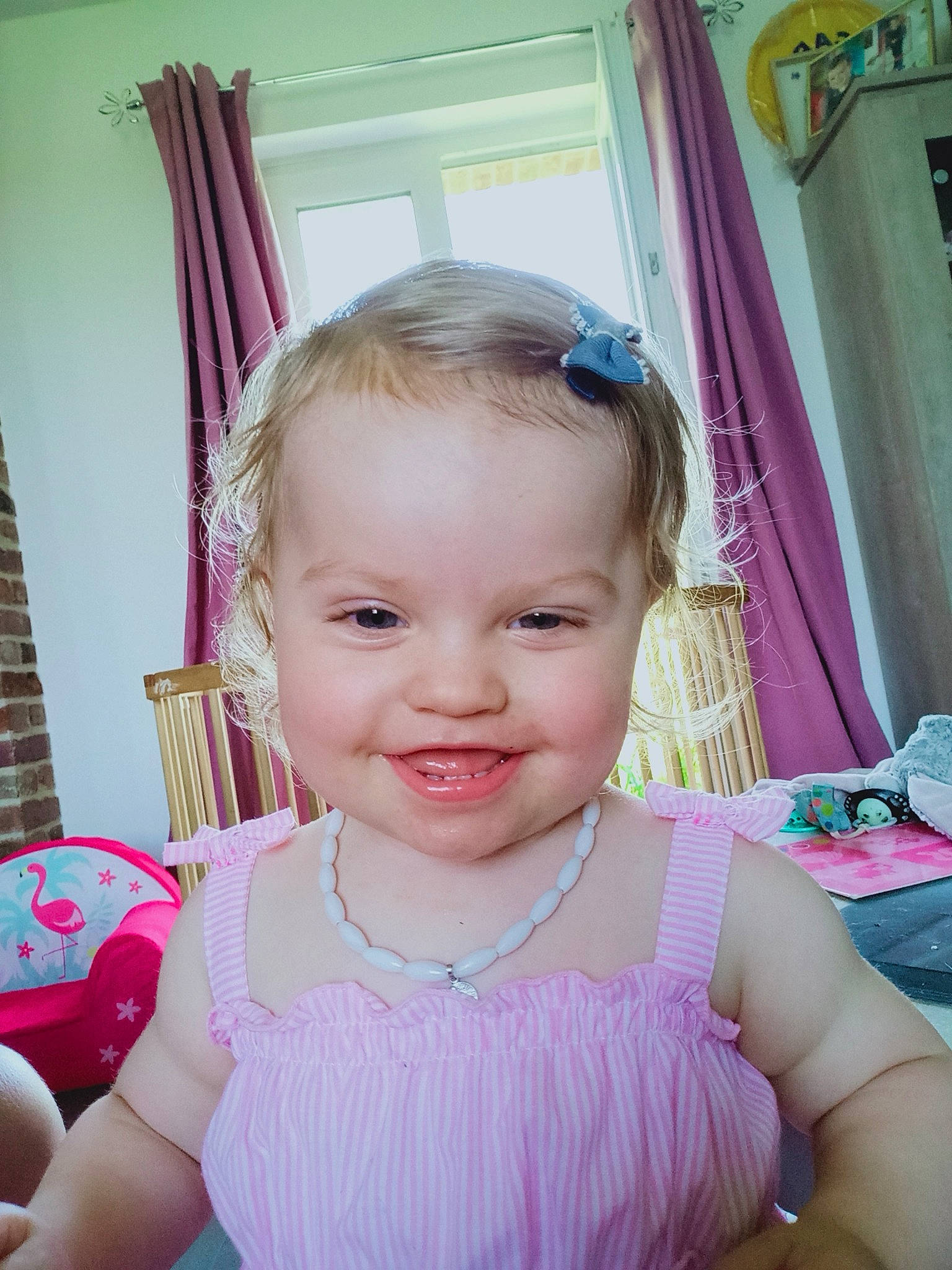 Brunhilde participe au concours pour gagner de l'argent avec cette photo : arm, baby, baby_toddler_clothing, cheek, curtain, eyelash, finger, fun, hairstyle, happy, iris, joy, lip, magenta, person, pink, purple, sitting, skin, smile