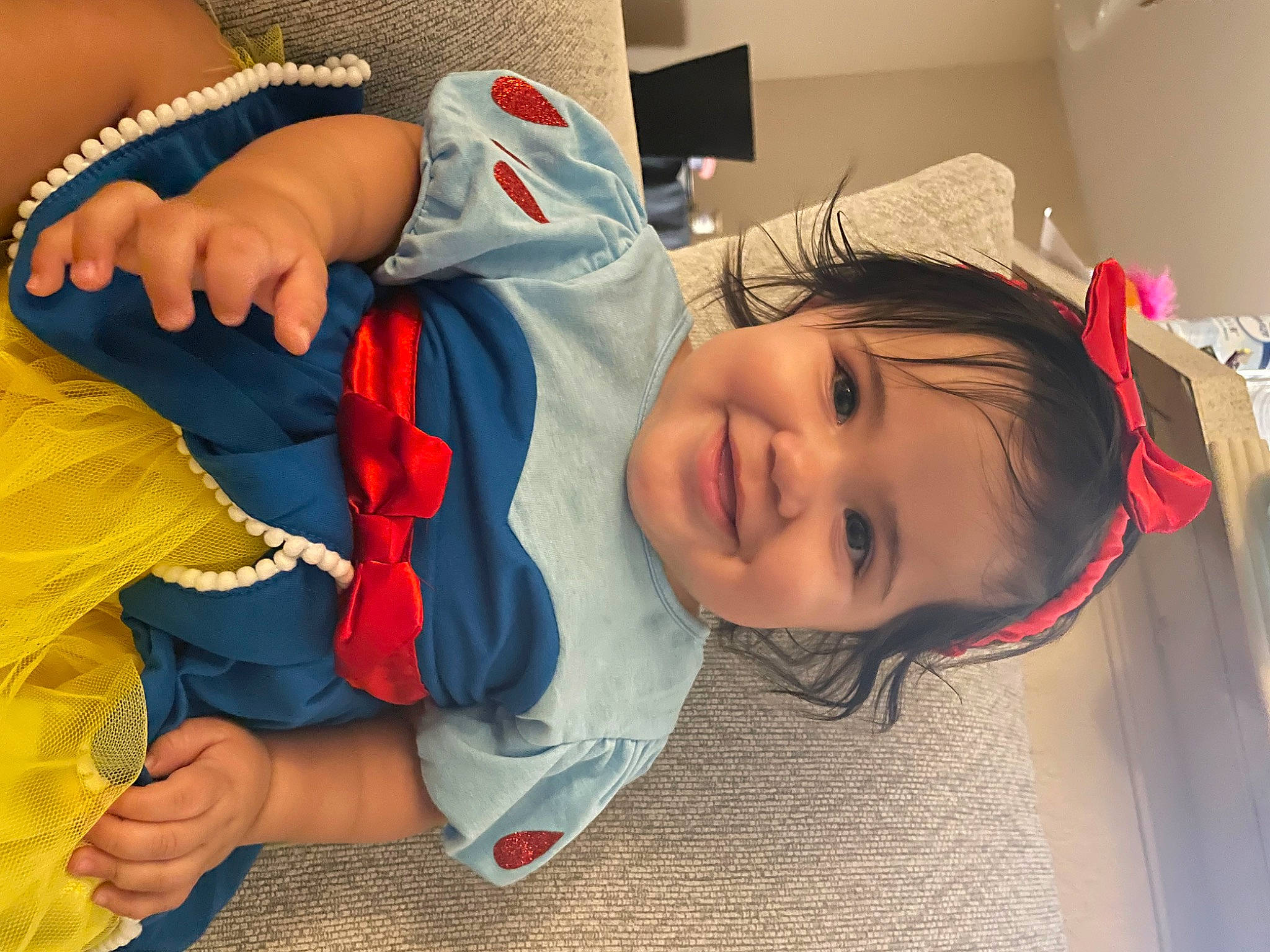 Brianna is registered to the contest to win money with this photo: abdomen, baby, baby_toddler_clothing, chest, child, comfort, elbow, electric_blue, flooring, fun, gesture, happy, joy, mouth, nail, person, room, skin, smile, thumb