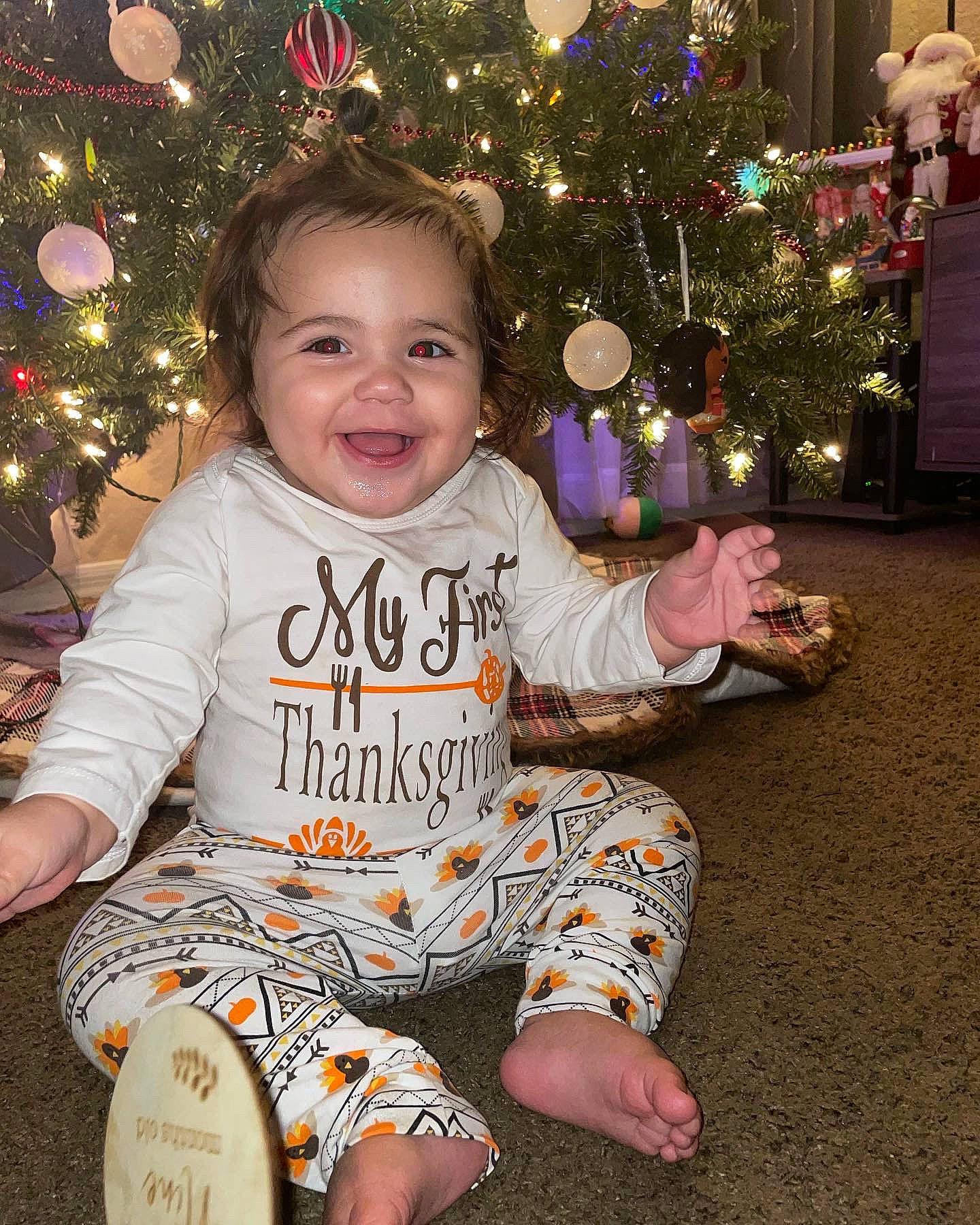 Brianna joined the competition — help win amazing prizes! baby_toddler_clothing, cheek, child, christmas_decoration, christmas_ornament, christmas_tree, facial_expression, fun, happy, head, holiday_ornament, human_body, joy, light, organ, people, person, sleeve, smile, standing