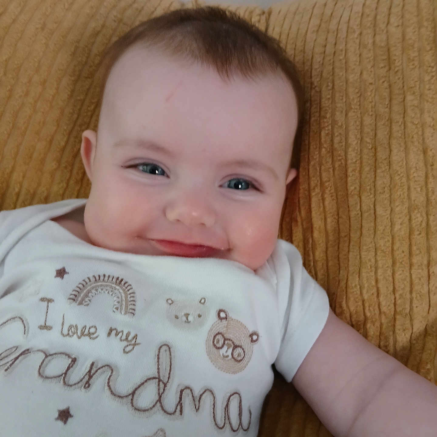 Willow is registered to the contest to win money with this photo: baby, bodypart, clothing, couch, cushion, face, finger, furniture, hand, happy, head, homedecor, newborn, person, photography, pillow, portrait, sitting, smile, t_shirt