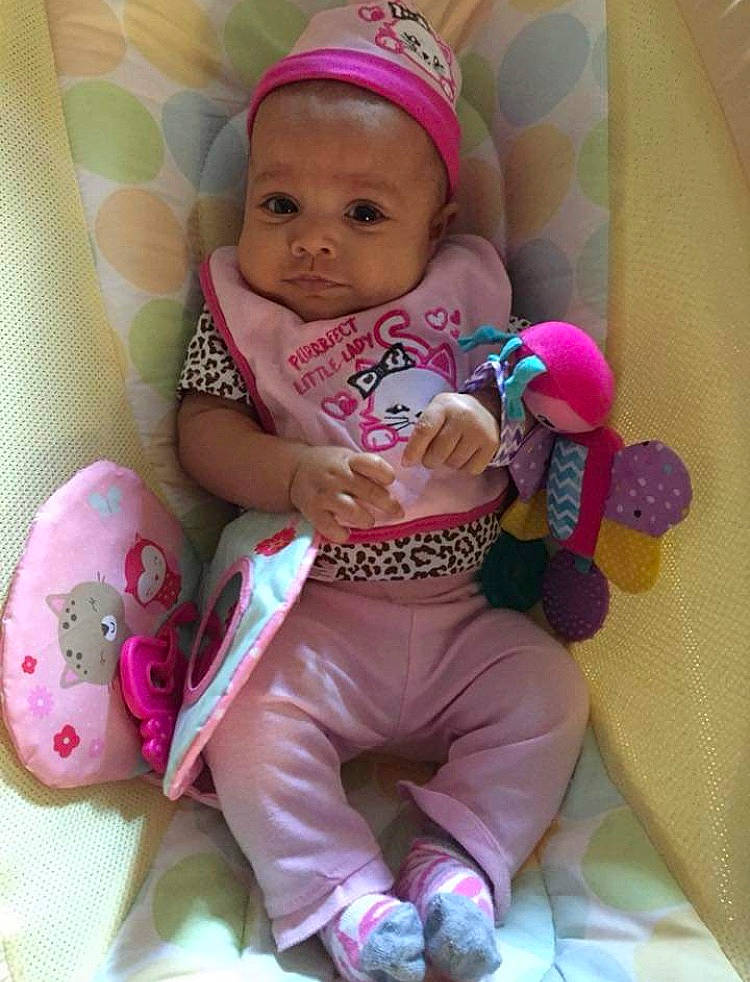 Myla is registered to the contest to win money with this photo: baby_products, cheek, child, girl, hair_accessory, infant, iris, person, pink, product, purple, skin, smile, stuffed_toy, textile, toddler, toy