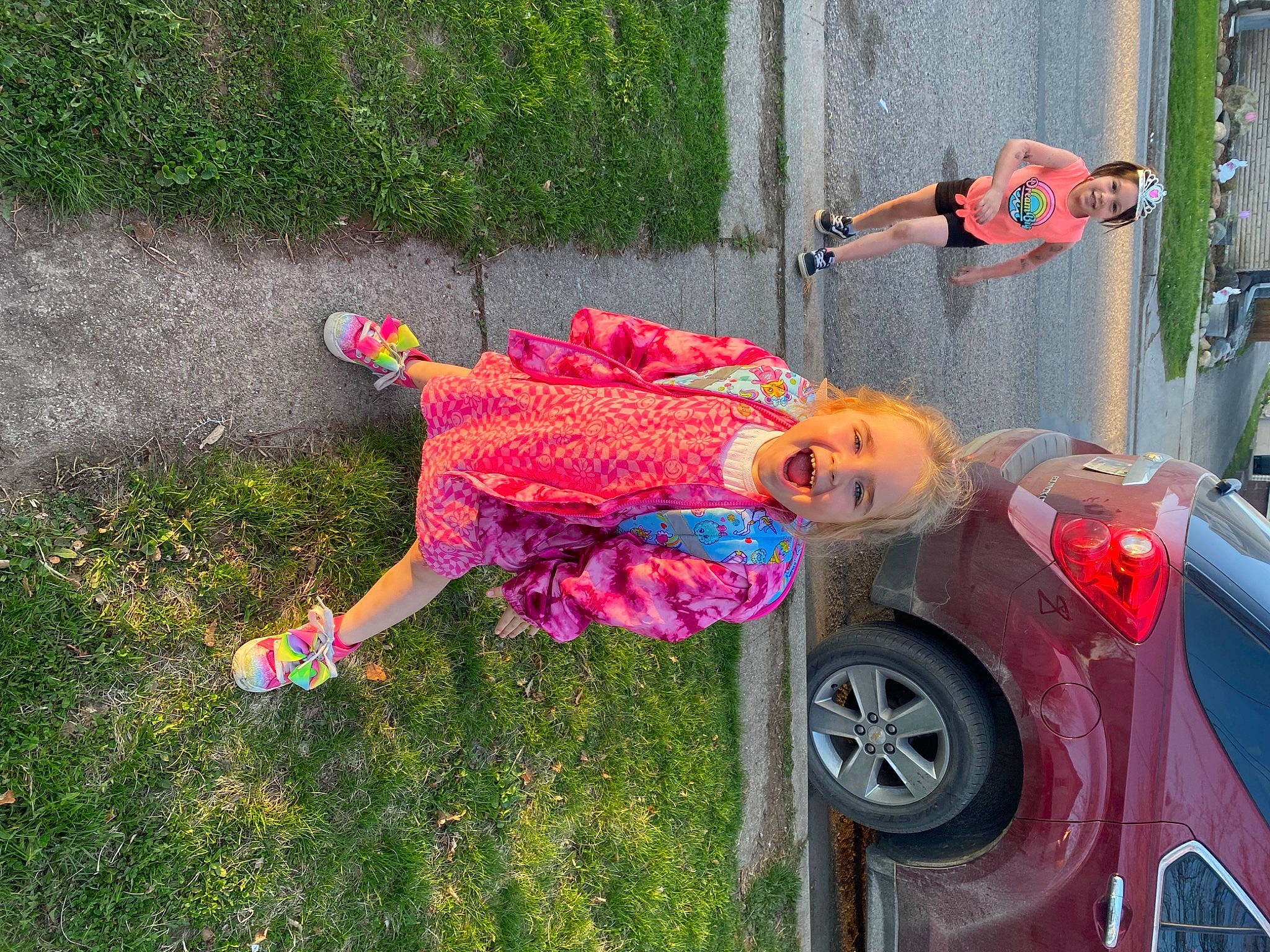 Madalyn joined the competition — help win amazing prizes! automotive_exterior, automotive_lighting, automotive_tire, bumper, car, door, fun, grass, headwear, joy, magenta, motor_vehicle, person, pink, plant, rim, tire, toddler, tree, vehicle