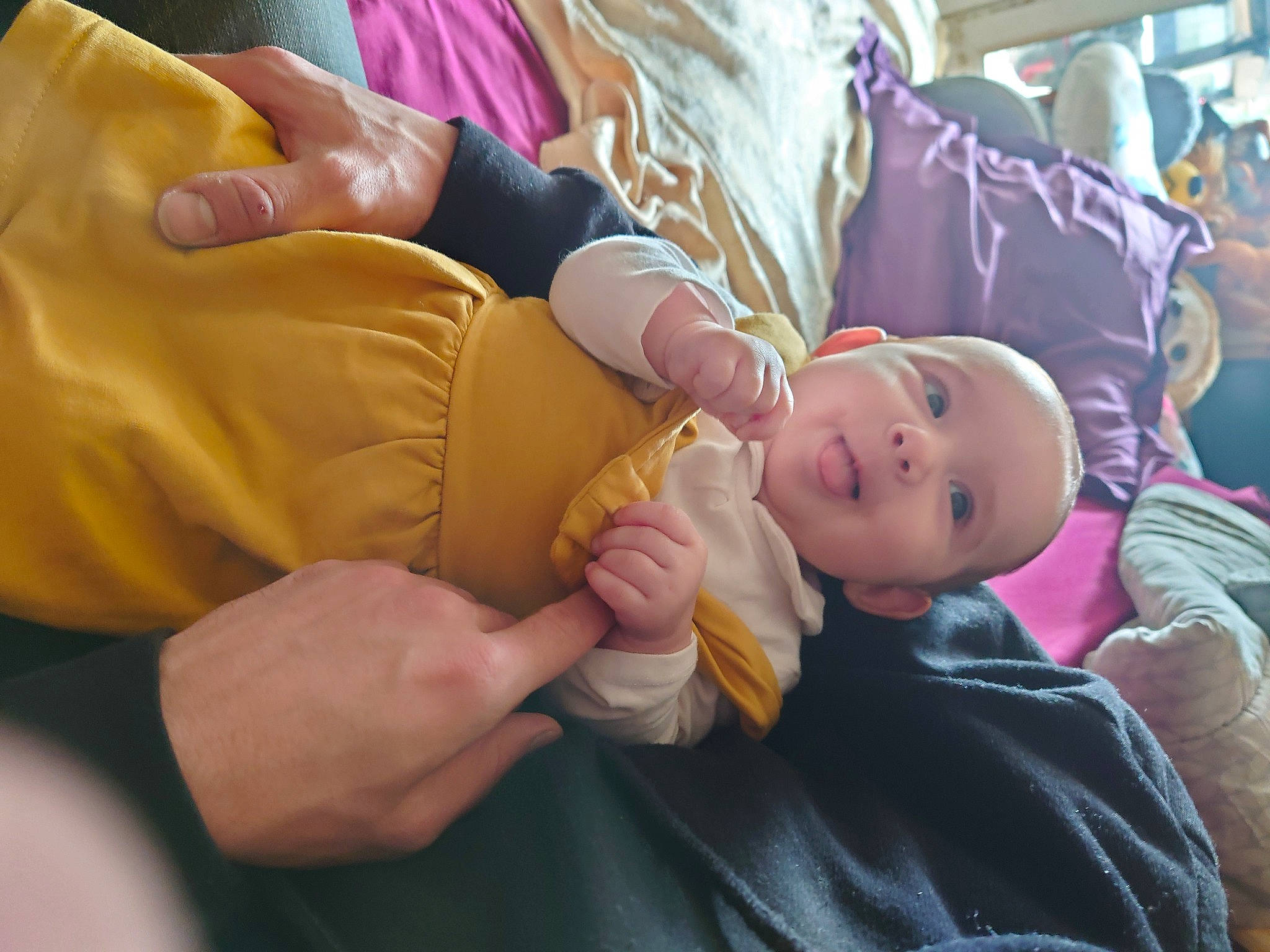 Mía participe au concours pour gagner de l'argent avec cette photo : baby, baby_products, cheek, child, comfort, finger, fun, gesture, hand, happy, hat, leisure, nail, person, purple, room, sitting, skin, smile, thumb