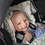 Oscar participe au concours pour gagner de l'argent avec cette photo : baby, smiling, car_seat, infant, toy, purple, cushion, blanket, child, face, happy, clothing, seatbelt, comfort, cute, closeup, indoors, person, head, expression