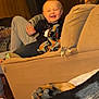 Laiklyn joined the competition — help win amazing prizes! toddler, child, couch, blanket, smiling, waving, dog, dog_paws, indoor, wood_panel_wall, person, furniture, cozy, happy, casual_clothing, living_room, home, cute, relaxed, pet