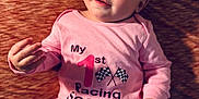Lakelynn is registered to the contest to win money with this photo: baby, infant, pink_onesie, blue_eyes, face, hand, lying_down, text_on_clothing, fabric_texture, cute, child, portrait, skin, expression, indoor, soft_lighting, small_child, casual_clothing, baby_girl, closeup