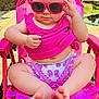 baby, child, sunglasses, pink_clothing, pink_chair, outdoor, deck, wood, summer, sunlight, cute, sitting, barefoot, infant, fashion, portrait, casual, greenery, relaxing, sunny