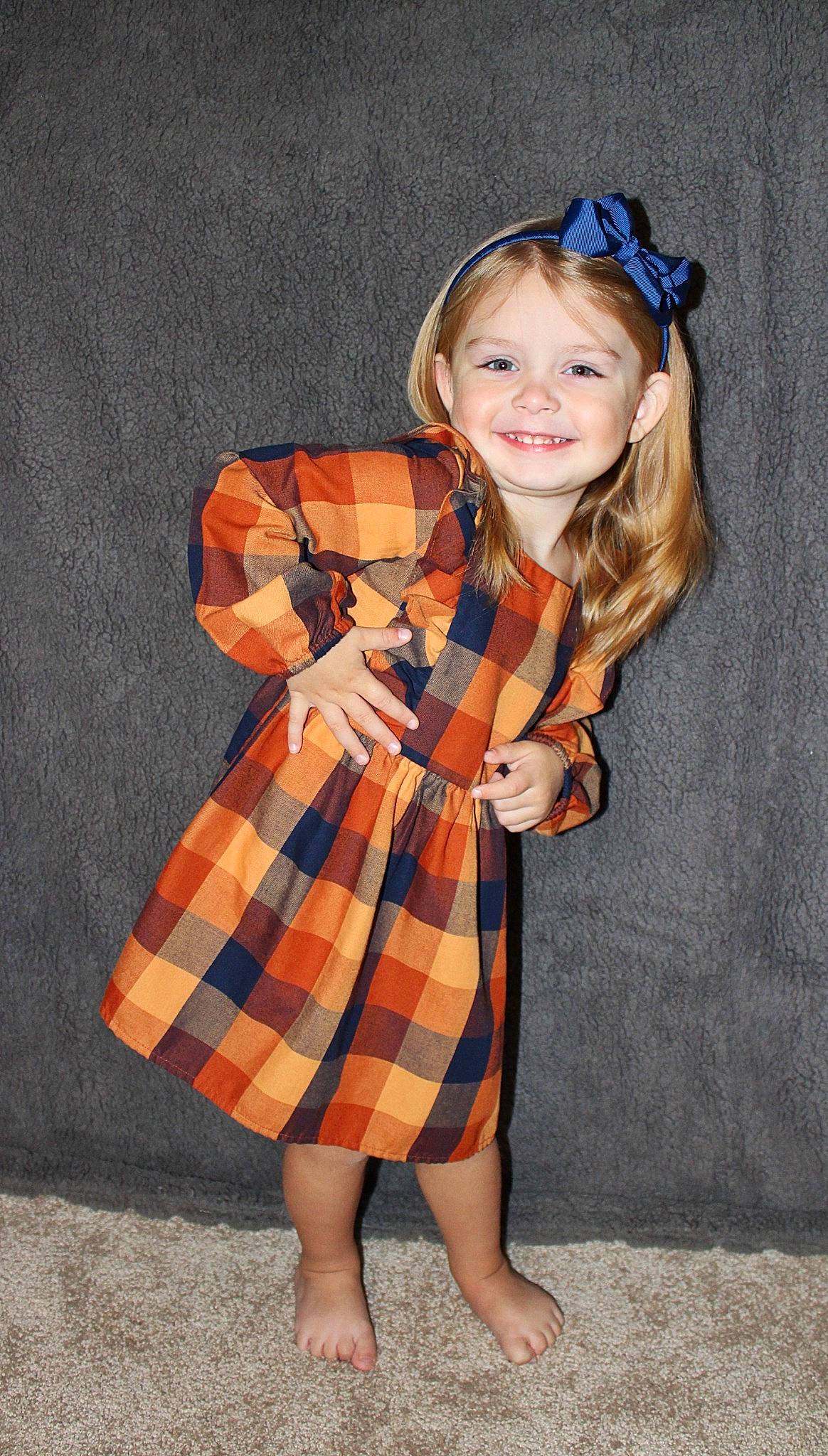 Elaine is registered to the contest to win money with this photo: arm, day_dress, dress, eye, face, hair, hand, head, human_body, joy, neck, one_piece_garment, orange, person, shoulder, skin, sleeve, smile, street_fashion, tartan