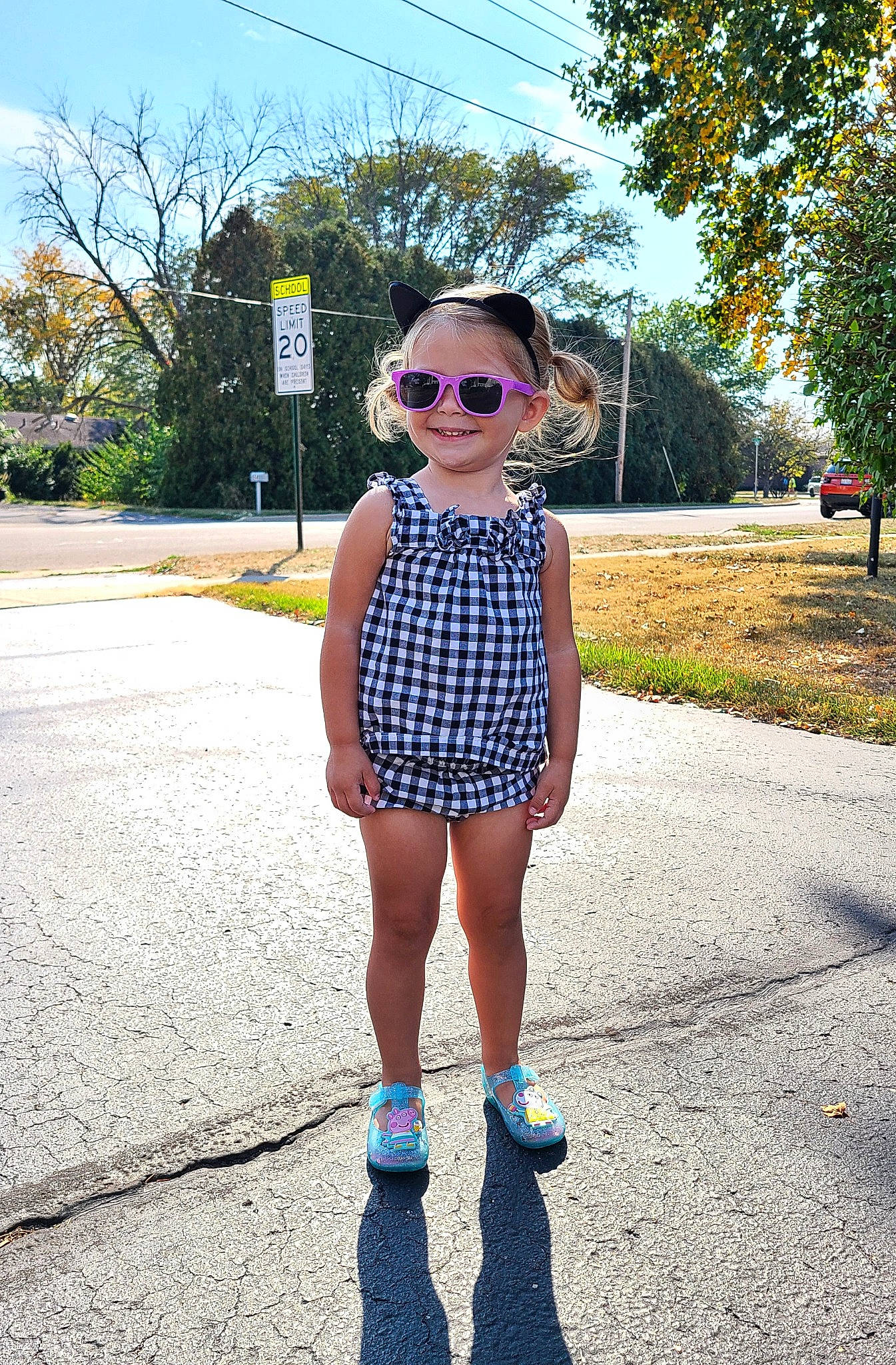 Elaine is registered to the contest to win money with this photo: asphalt, baby_toddler_clothing, cool, denim, electric_blue, eyewear, joy, leisure, person, plaid, plant, road, road_surface, sky, sleeve, street_fashion, sunglasses, t_shirt, toddler, travel
