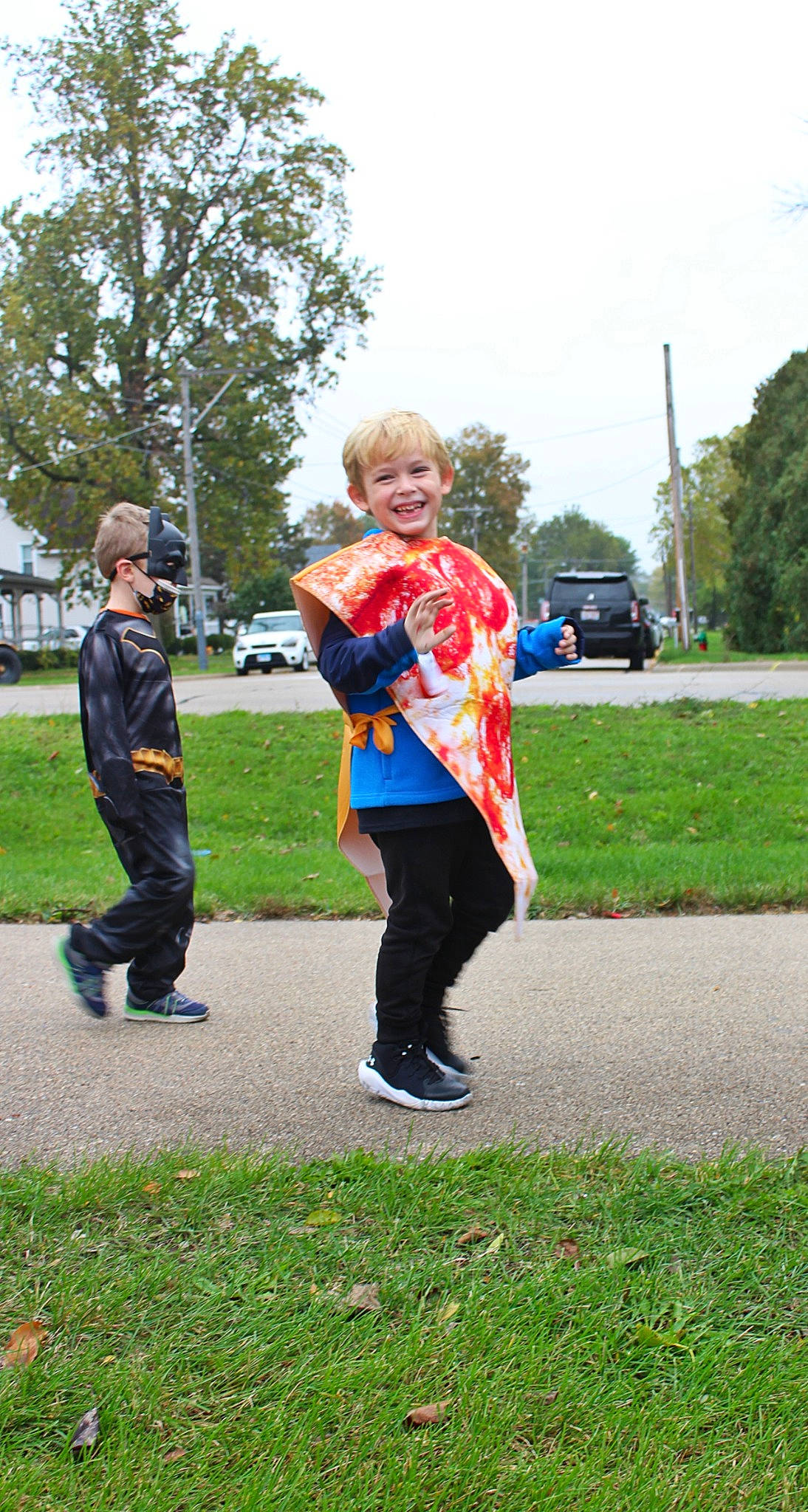 Mason is registered to the contest to win money with this photo: car, competition_event, electric_blue, event, fun, gesture, grass, jeans, joy, leg, leisure, people_in_nature, person, plant, pole, recreation, sky, smile, t_shirt, toddler