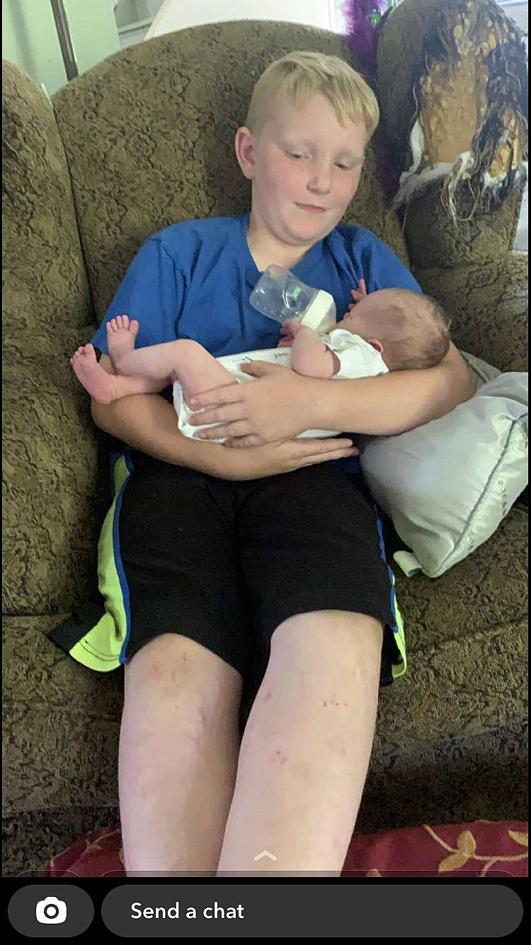 Michael is registered to the contest to win money with this photo: abdomen, arm, baby, comfort, couch, elbow, fun, human, human_leg, knee, lap, muscle, organ, person, shorts, shoulder, stomach, t_shirt, thigh, toddler