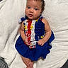 Saniyah joined the competition — help win amazing prizes! baby, infant, child, portrait, lying_down, blanket, white_blanket, colorful_clothing, red, white, blue, dress, barefoot, brown_hair, blue_eyes, looking_at_camera, indoors, textile, cute, photography