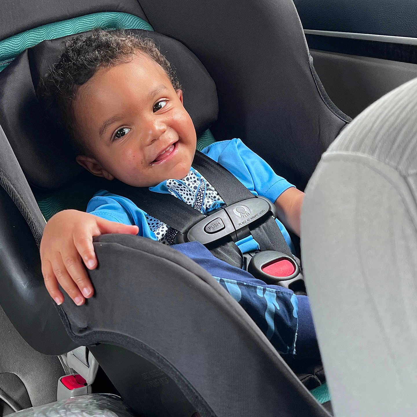 Grayson is registered to the contest to win money with this photo: accessories, baby, bodypart, car, car_interior, carseat, cushion, face, finger, hand, happy, head, homedecor, person, photography, portrait, sitting, smile, transportation, vehicle