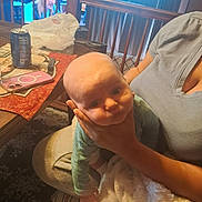 Jayden is registered to the contest to win money with this photo: baby, child, person, adult, hand, blanket, table, phone, can, indoor, curious, sitting, clothing, face, holding, furniture, carpet, curtain, light, casual