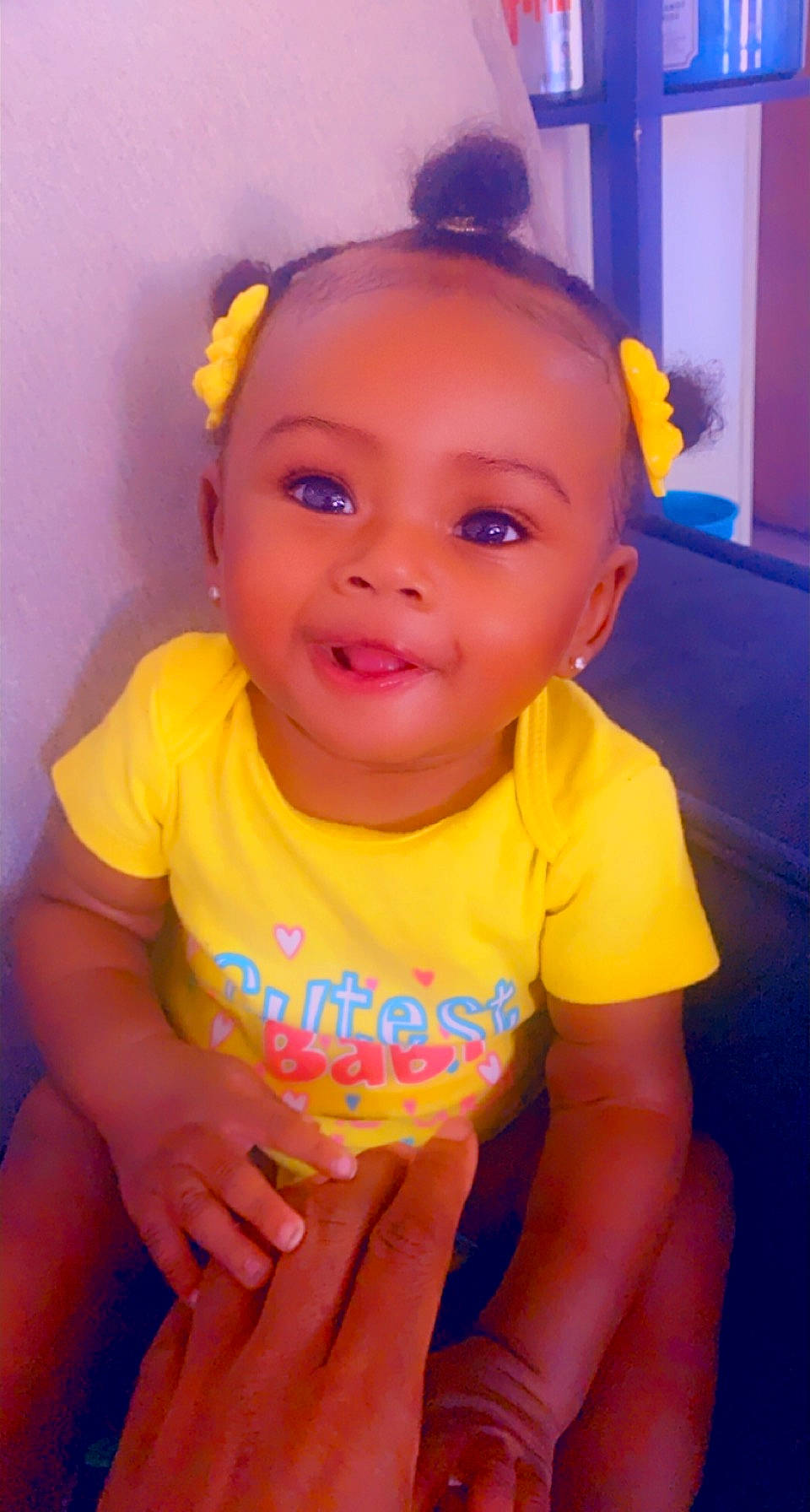 Nia is registered to the contest to win money with this photo: baby_toddler_clothing, cheek, chin, facial_expression, gesture, hairstyle, hand, happy, head, iris, joy, lip, mouth, neck, nose, orange, person, pink, purple, skin