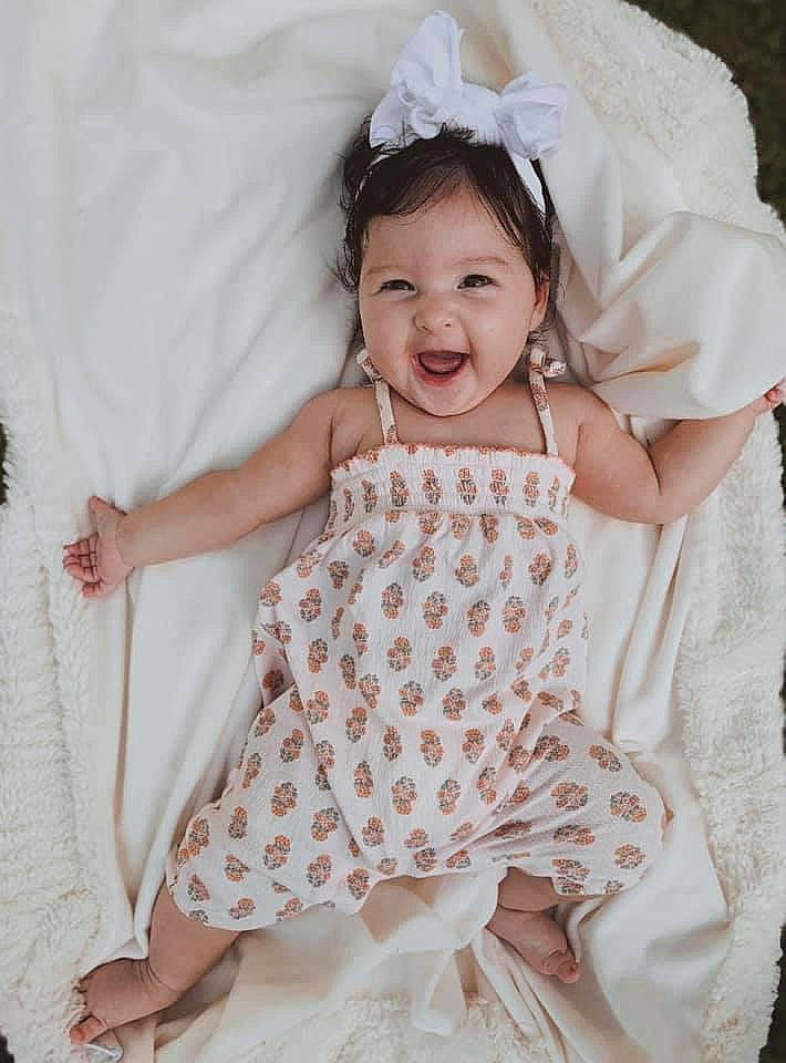 Giavanna is registered to the contest to win money with this photo: baby, baby_products, baby_toddler_clothing, child, child_model, design, dress, fashion_accessory, hair_accessory, headpiece, pattern, person, photography, pink, product, skin, smile, textile, toddler, white