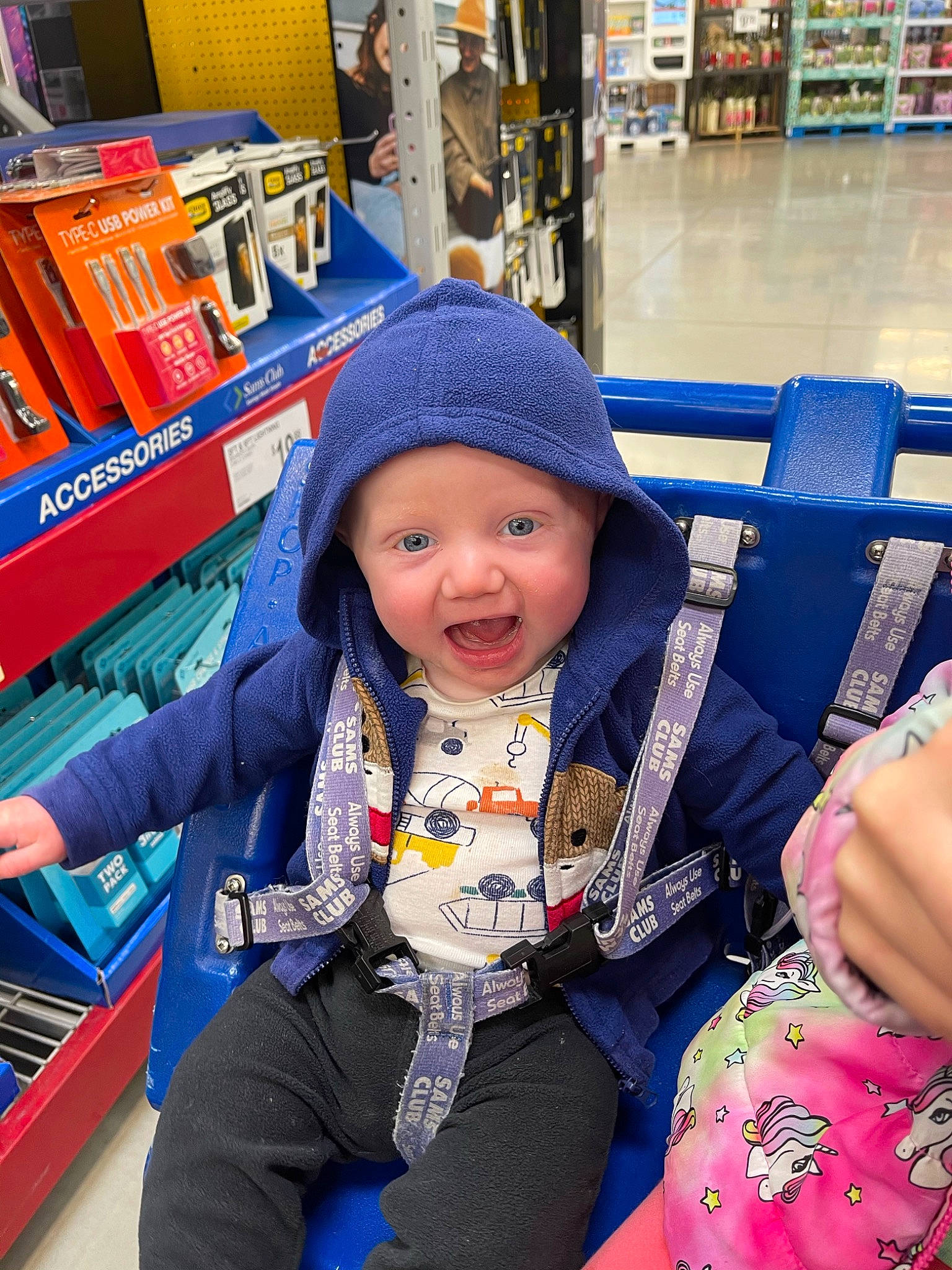 Jordan is registered to the contest to win money with this photo: baby, baby_toddler_clothing, blue, cap, child, customer, electric_blue, fun, happy, headwear, leisure, person, photograph, product, retail, shelf, shopping, smile, standing, toddler