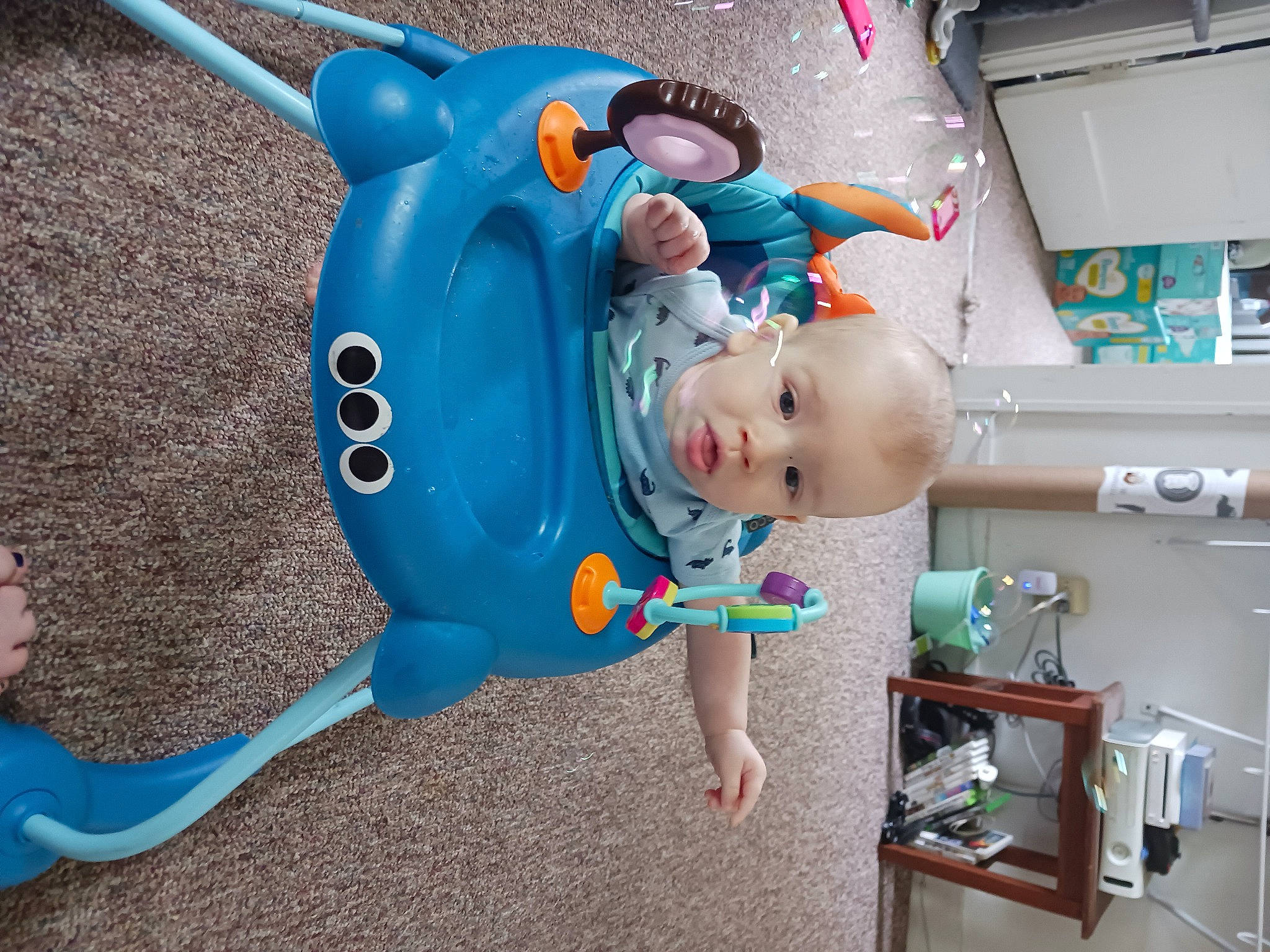 Aj is registered to the contest to win money with this photo: animation, baby, baby_products, baby_safety, baby_toddler_clothing, baby_toys, child, electric_blue, fictional_character, fun, garden_tool, person, plastic, play, product, recreation, shelf, t_shirt, toddler, tool