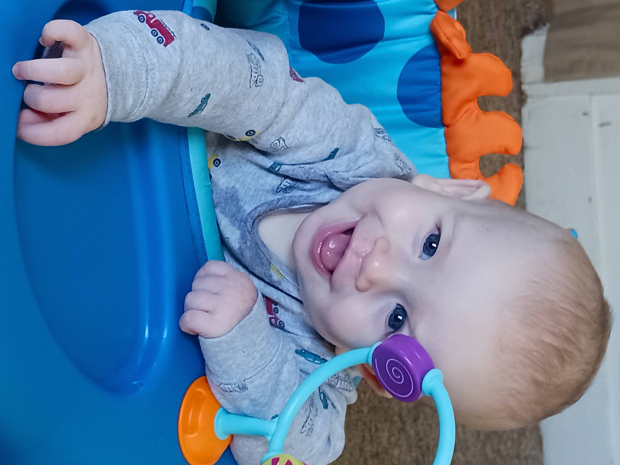 Aj is registered to the contest to win money with this photo: arm, baby, baby_toddler_clothing, blue, cheek, finger, fun, gesture, hand, happy, head, mouth, nose, organ, person, product, red, skin, smile, toddler