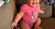 Tatum is registered to the contest to win money with this photo: baby, blanket, casual, child, couch, cozy, cute, face, furniture, happy, home, indoor, infant, person, pink_onesie, portrait, sitting, skin, smiling, young_child