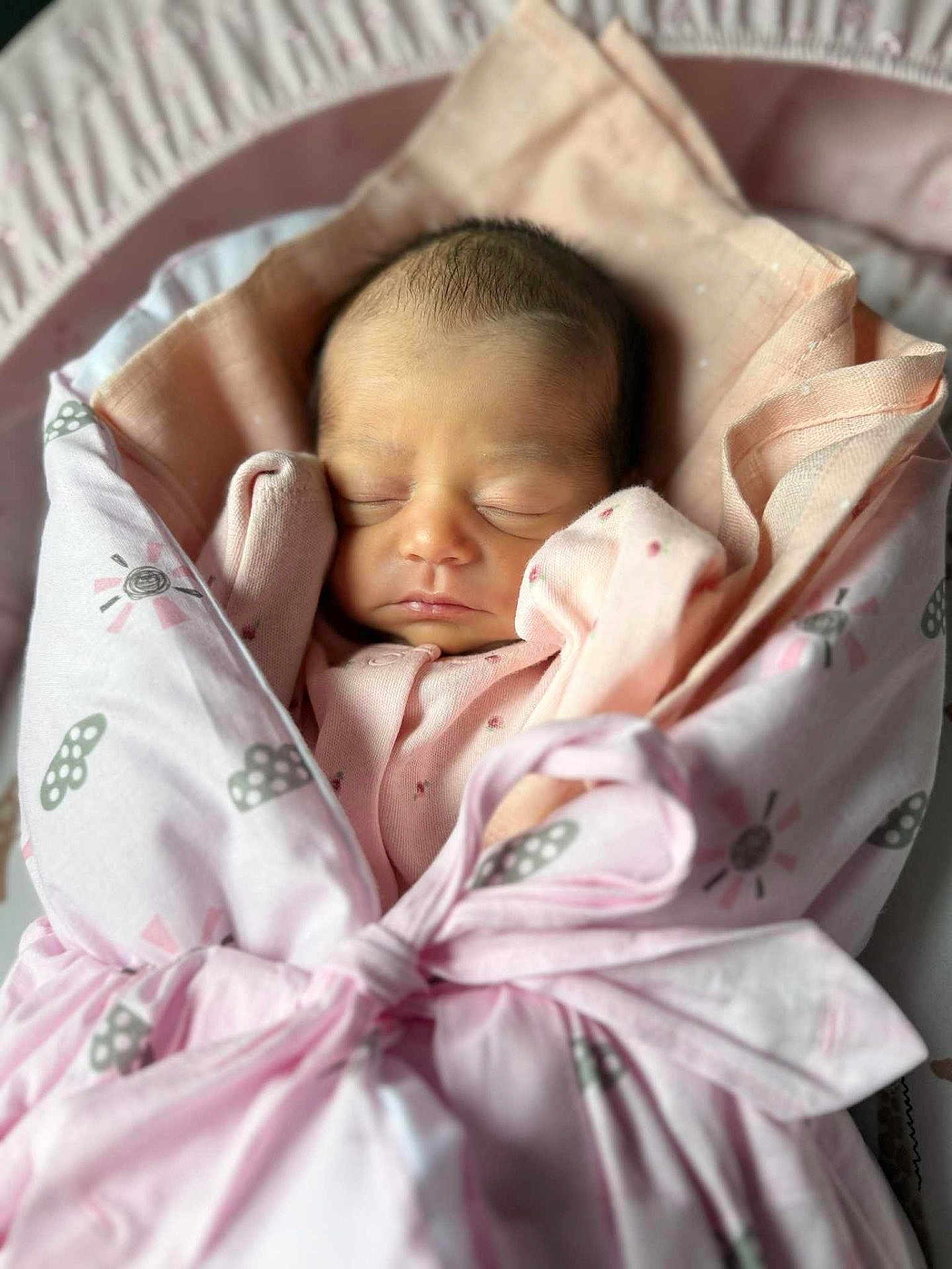 Milah joined the competition — help win amazing prizes! newborn, baby, sleeping, pink_blanket, wrapped, infant, cozy, soft_fabric, cute_pattern, peaceful, child, tied_bow, indoors, portrait, closeup, head, face, sleepwear, resting, adorable