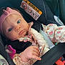 baby, child, car_seat, seatbelt, pink_bow, pacifier, toy, floral_clothing, headband, infant, car_interior, safety, cute, portrait, young_child, hand, face, blue_eyes, clothing, seat