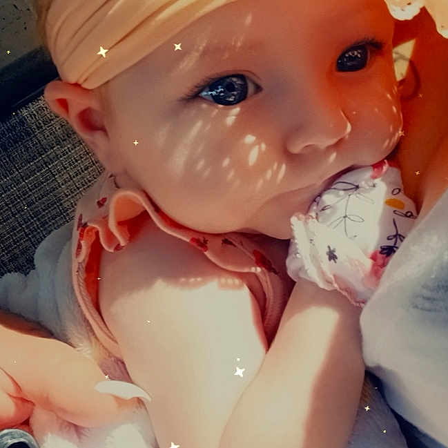 Brooklynn is registered to the contest to win money with this photo: baby, bathing, blond, cheek, chest, child, doll, dress, eyelash, fashion_accessory, figurine, iris, lip, peach, petal, pink, plastic, skin, toddler, toy