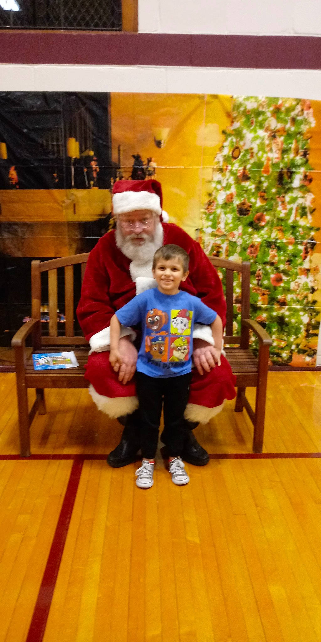 Gunner is registered to the contest to win money with this photo: child, christmas, christmas_eve, christmas_tree, fictional_character, headwear, holiday, joy, lap, person, santa_claus, toddler