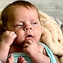 Arthur is registered to the contest to win money with this photo: baby, infant, blanket, blue_clothing, closeup, face, fist, skin, expression, newborn, person, portrait, soft_texture, warm, cozy, indoor, sleepy, cute, child, wrapped
