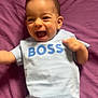 Naël participe au concours pour gagner de l'argent avec cette photo : baby, blue_shirt, boss_text, casual, cheerful, child, clothing, cute, expressive, happy, indoor, infant, jeans, laughing, lying_down, person, portrait, purple_blanket, smiling, young_child