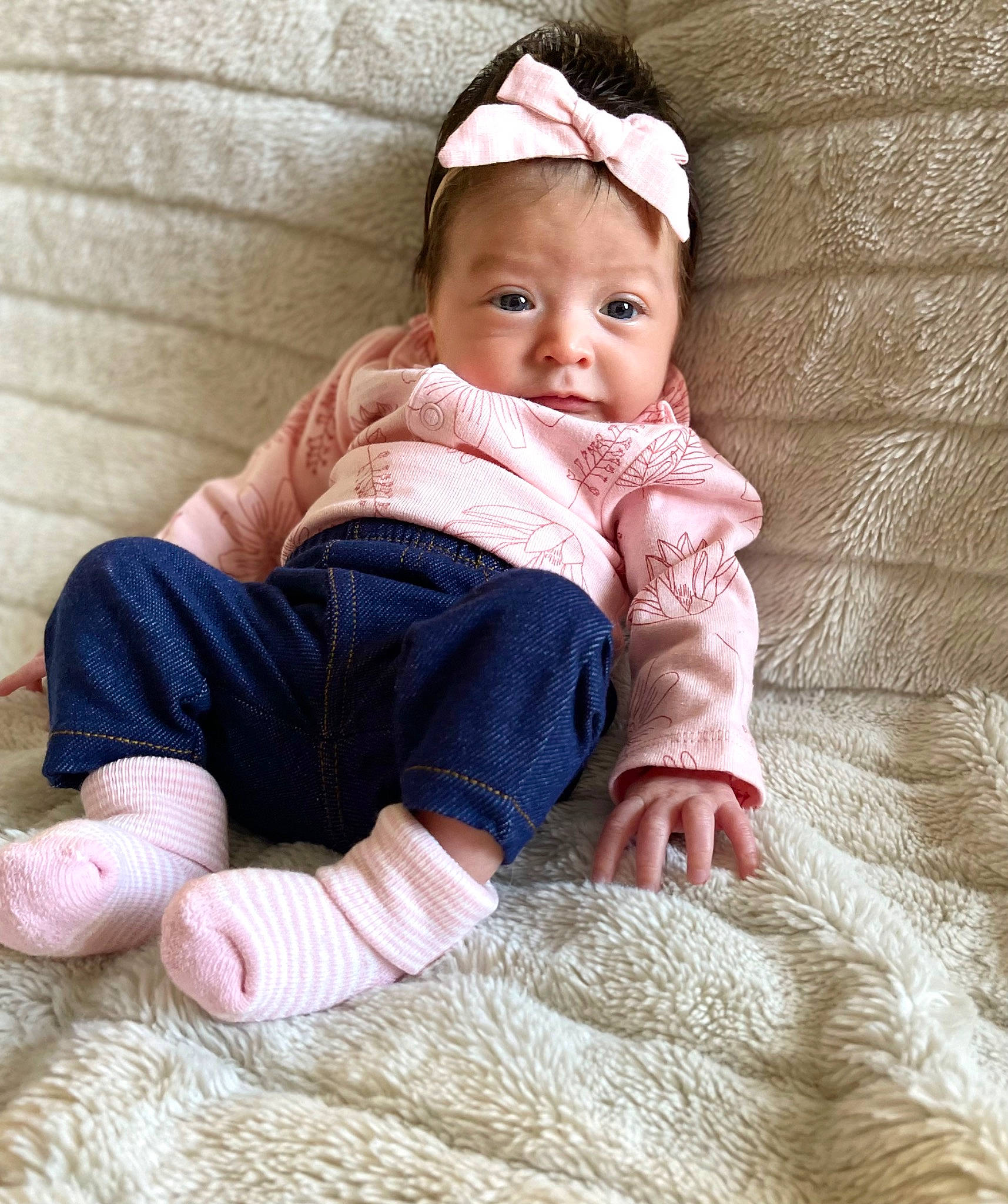 Lexi is registered to the contest to win money with this photo: baby, baby_toddler_clothing, barefoot, cap, cheek, comfort, eye, face, finger, flooring, foot, human_leg, linens, pattern, person, sitting, skin, sleeve, sock, toddler